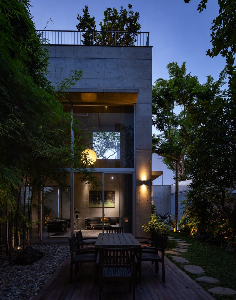Rear garden and lit interior at dusk