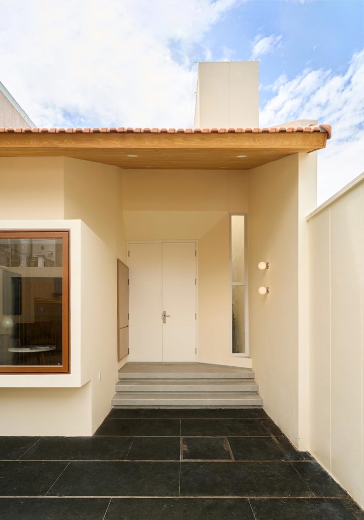 Front door and window under the deep roof edge