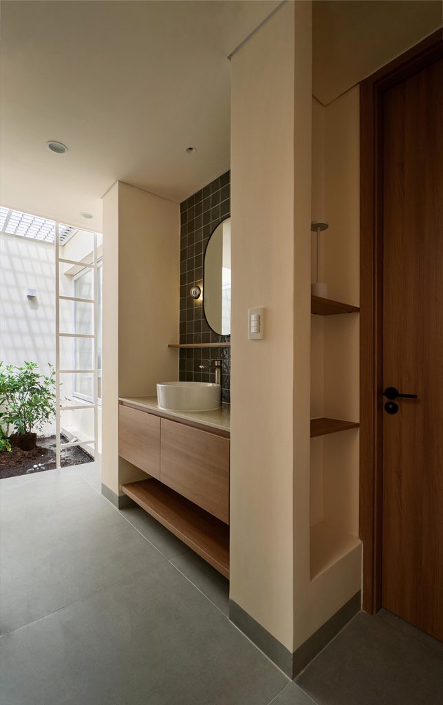 Bathroom washbasin beside a planted lightwell