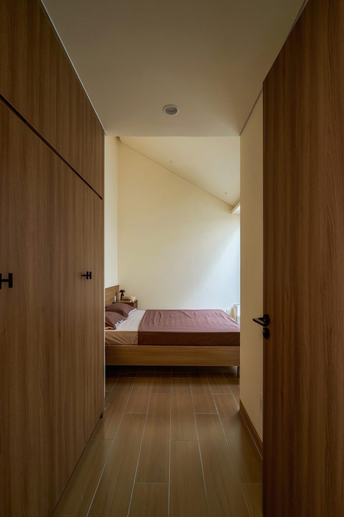 Bedroom seen through a timber-framed doorway