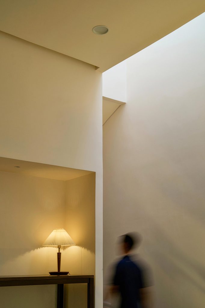 Light falling down a tall wall beside a low space
