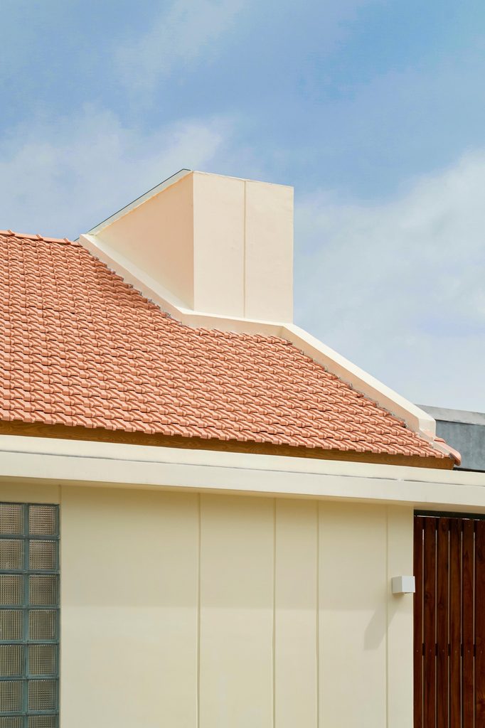 Red tiled roof and pale chimney volume