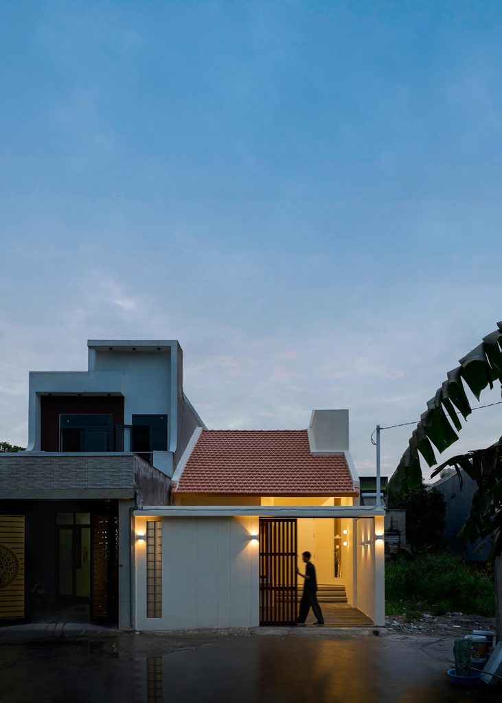The house glowing at dusk