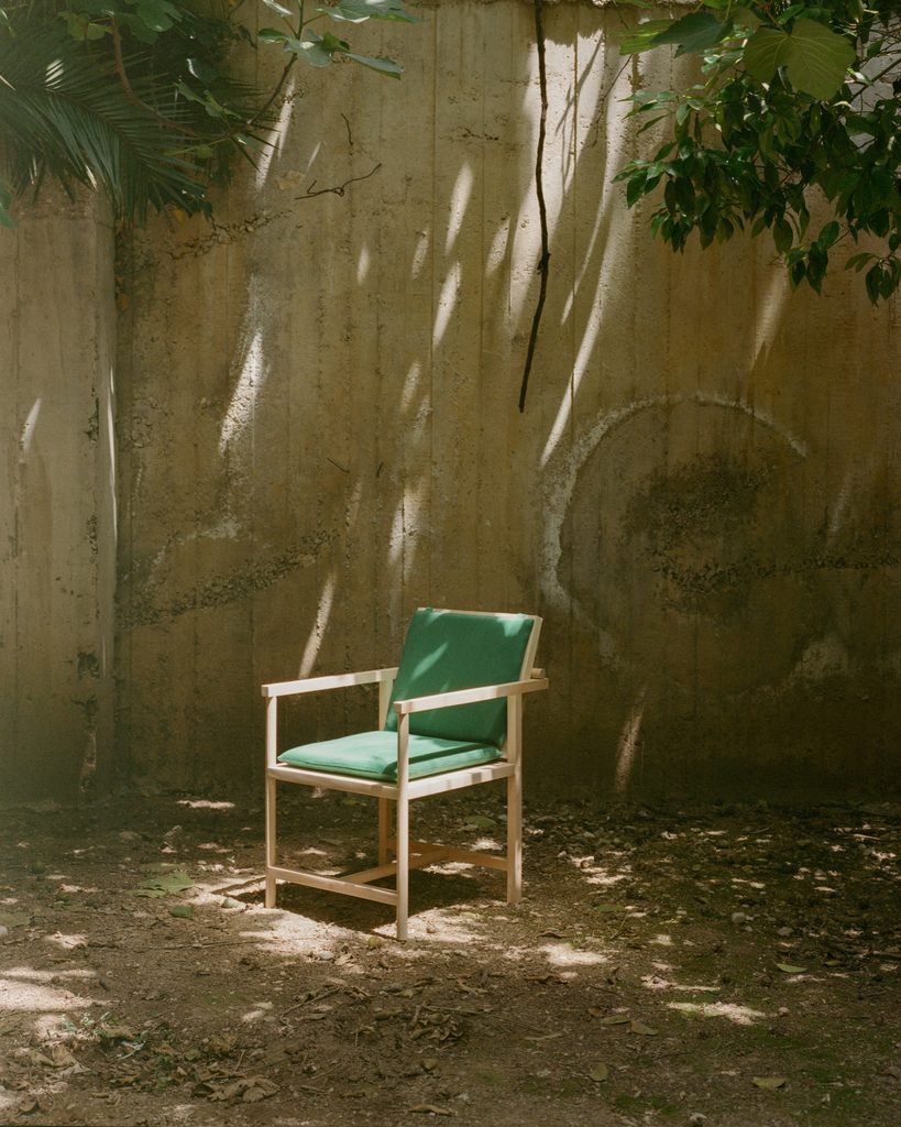 Parrot Chair under tree shade in a courtyard.