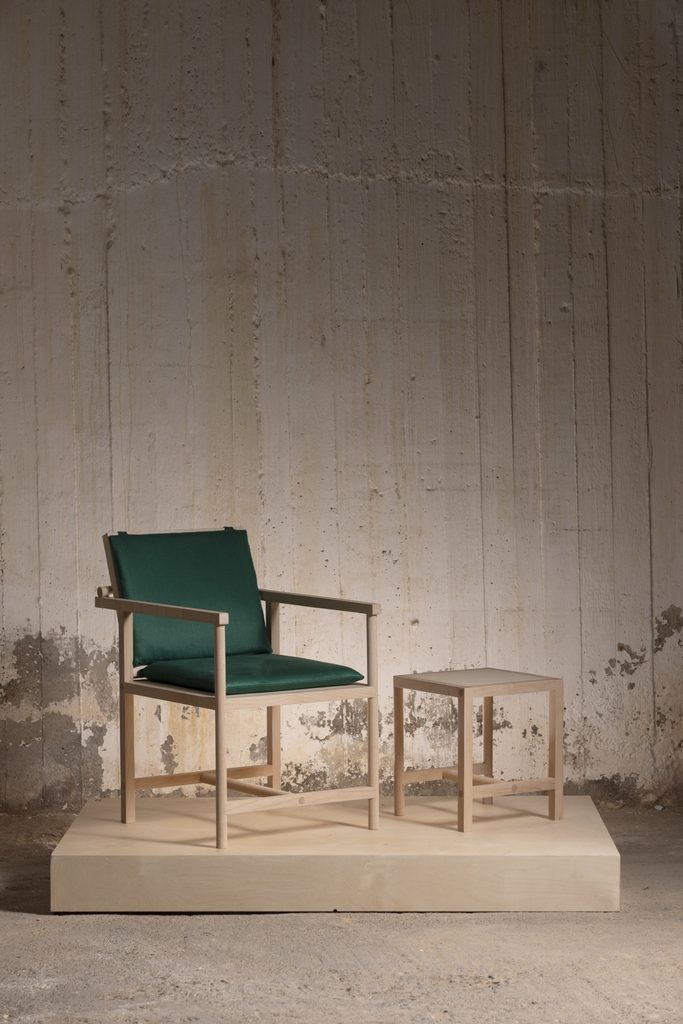 Maple Parrot Chair with matching stool on a raised display platform.