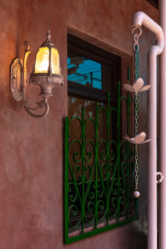Exterior wall light and decorative metal grille