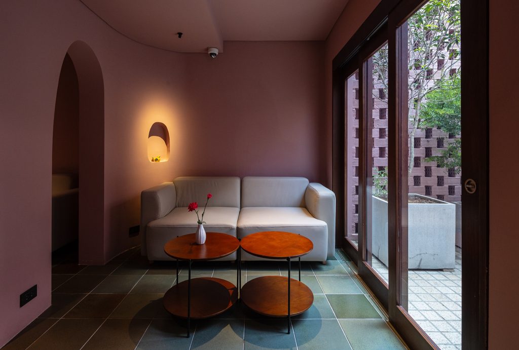 Sofa beside timber-framed courtyard doors