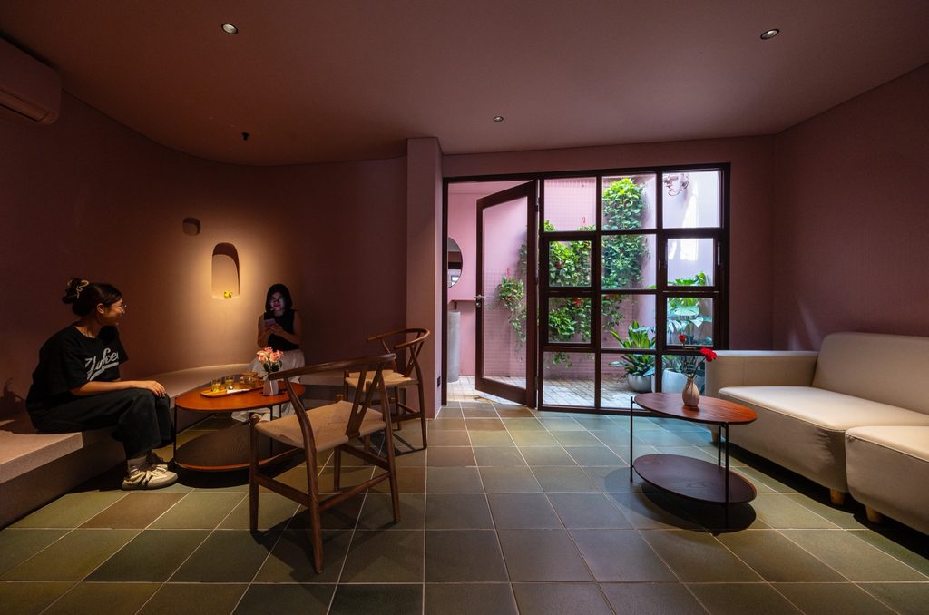 Lounge seating beside courtyard windows