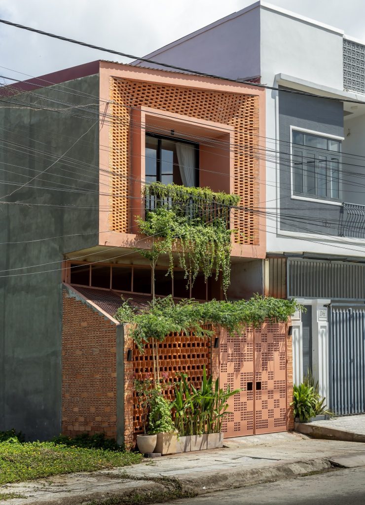 Street facade with a recessed balcony and perforated brick screen
