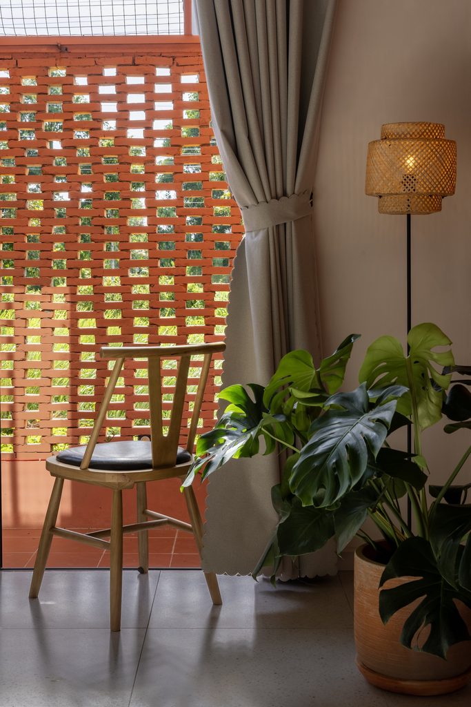 Bedroom chair beside the perforated terracotta screen
