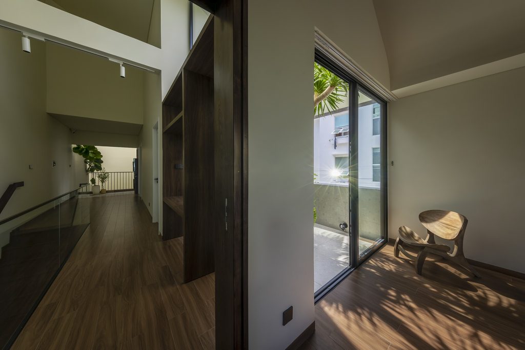 Timber-floored upper landing beside a glazed courtyard