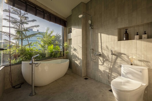 Bathroom with a freestanding bath beside a garden window