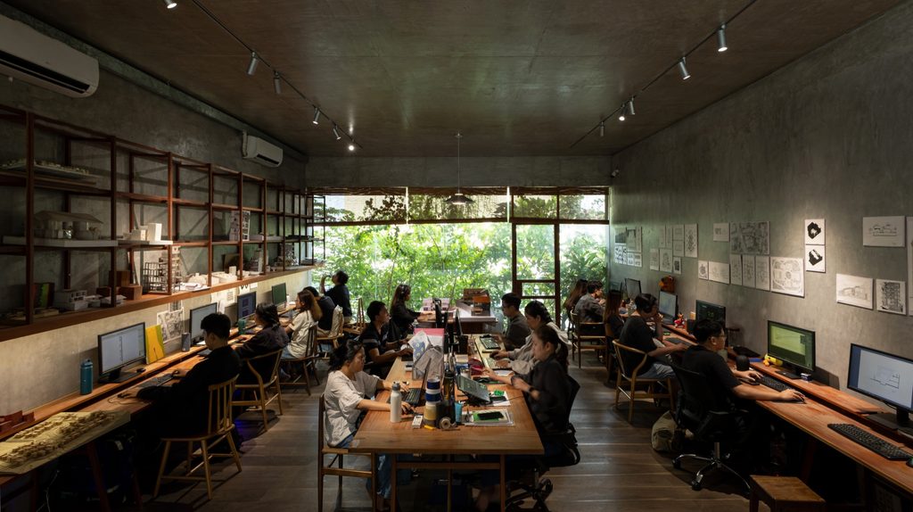 Studio floor with staff at shared desks