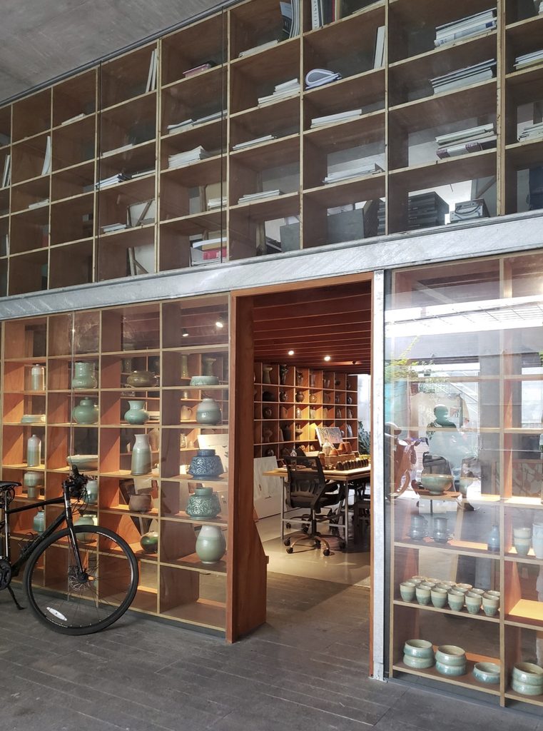 Full-height timber shelving at the entrance