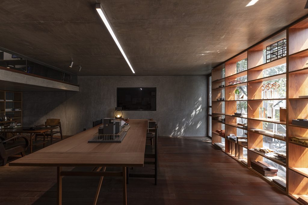 Meeting table along a wall of shelves