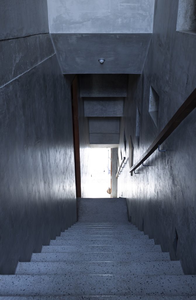 Narrow stair in dark concrete