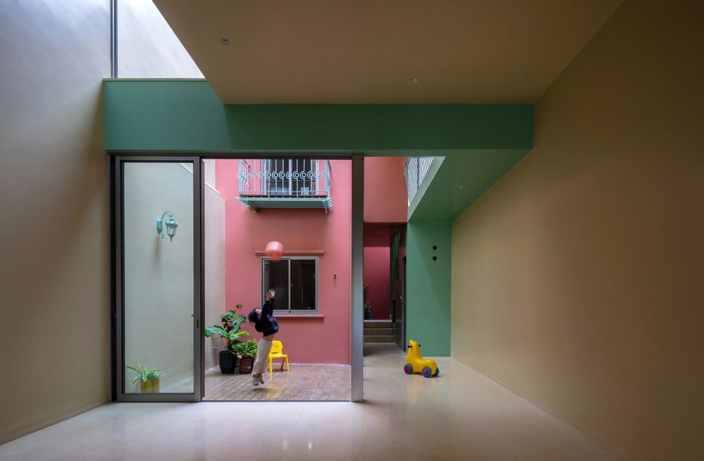 Ground-floor room opening onto the courtyard through sliding glass doors