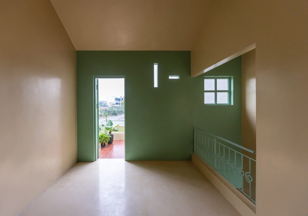 Upper room opening onto the terrace through a green doorway