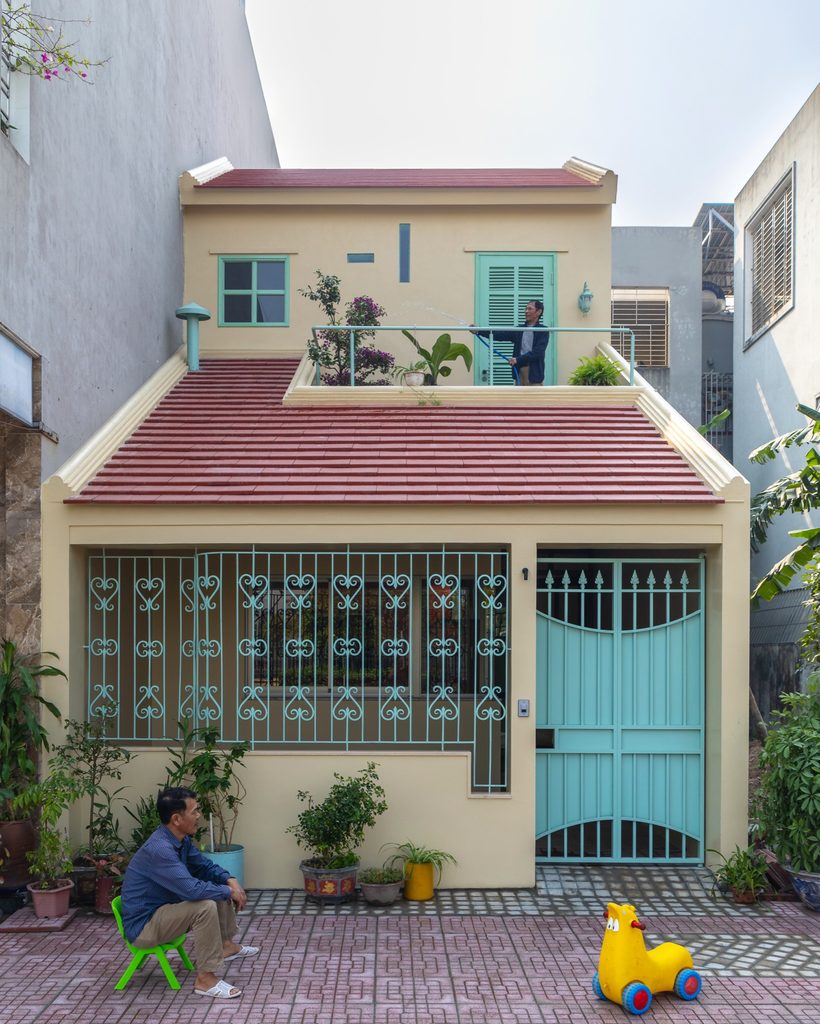 Front gate and window grilles beneath a tiled canopy