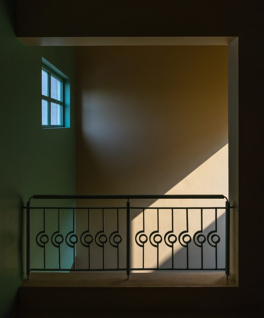 Sunlight on an upper landing and decorative metal railing