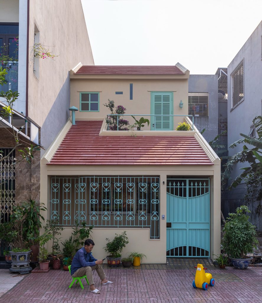 Front facade with an upper terrace and green entrance gate