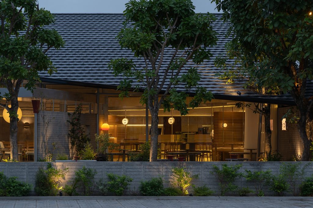 The café seen across the garden at dusk