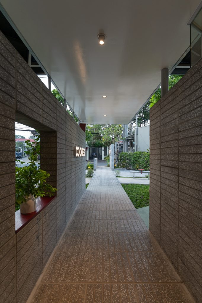Narrow covered passage between brick walls