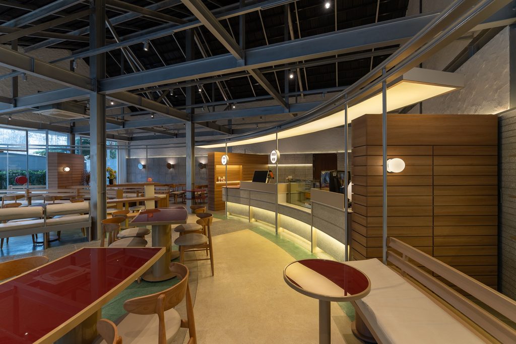 Red tables along the curved counter