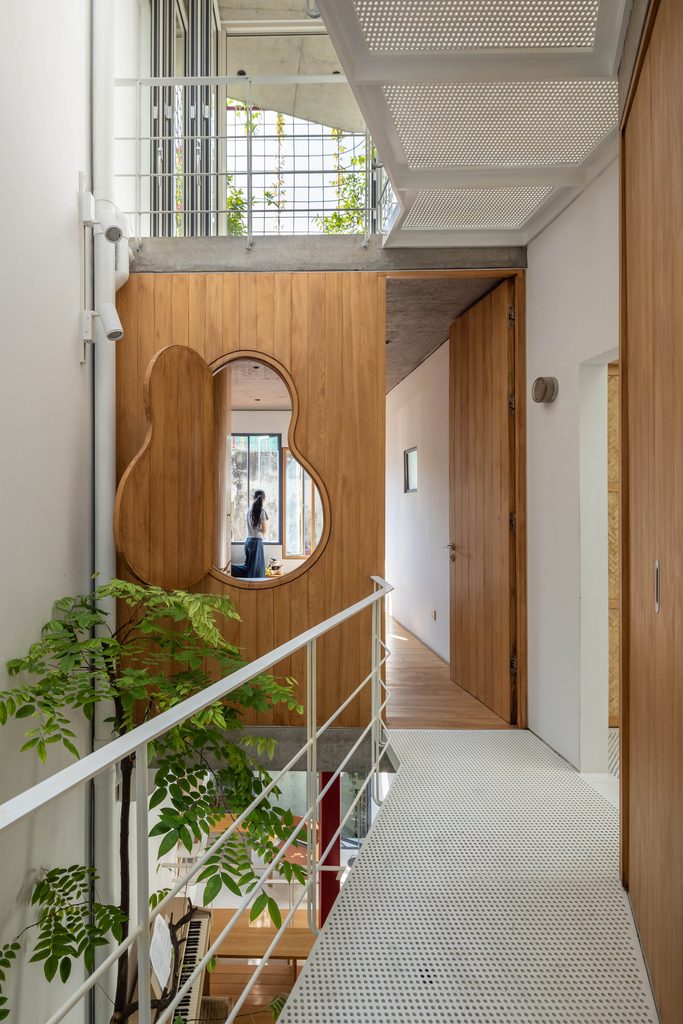 White metal walkway beside a timber wall with a curved opening