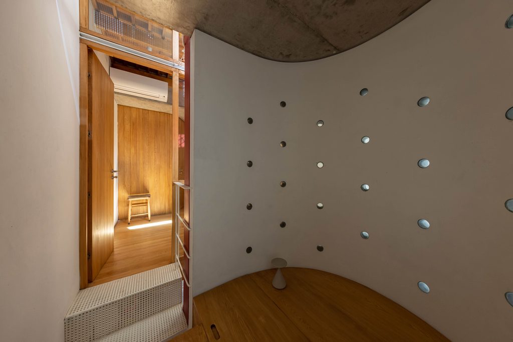 Small timber alcove with circular openings in the wall