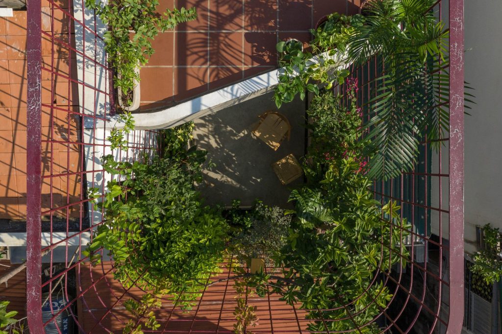 Overhead view of the roof terrace and curved red trellis