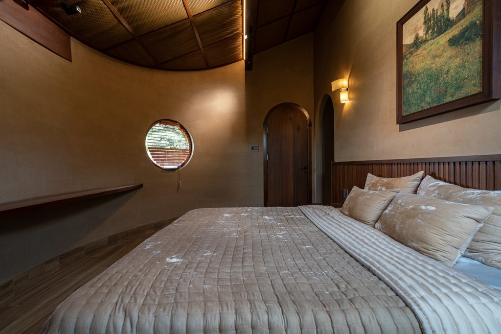 Bedroom interior with curved wall and round window