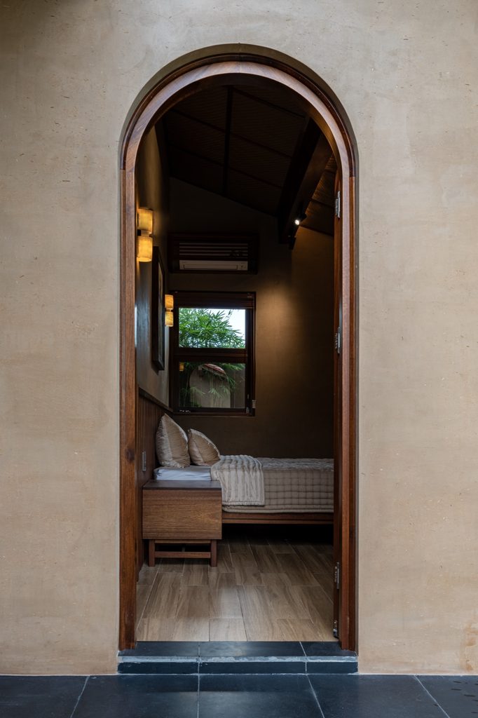 Arched doorway opening into a bedroom