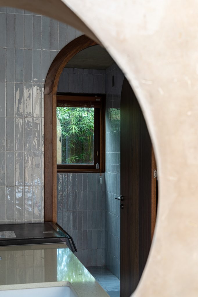 Bathroom doorway framed by a curved wall