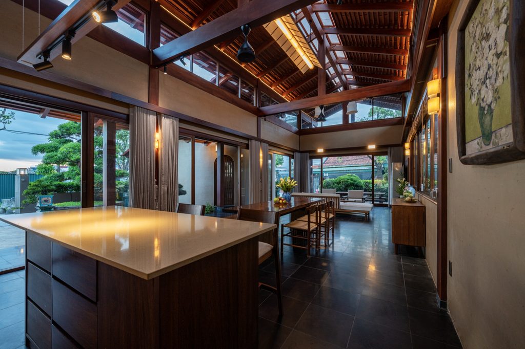 Dining area and kitchen island beneath the timber roof