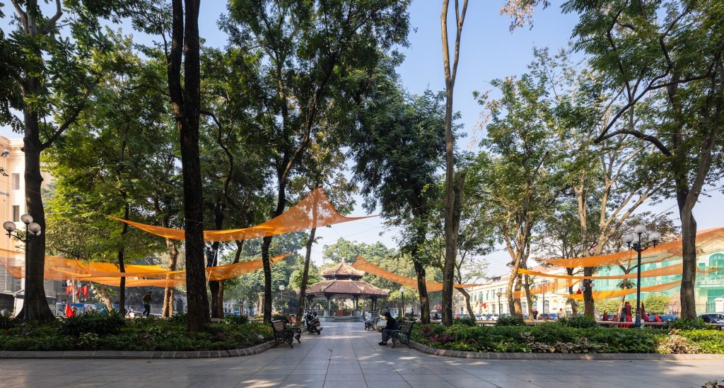 Orange canopies strung through the trees across the park