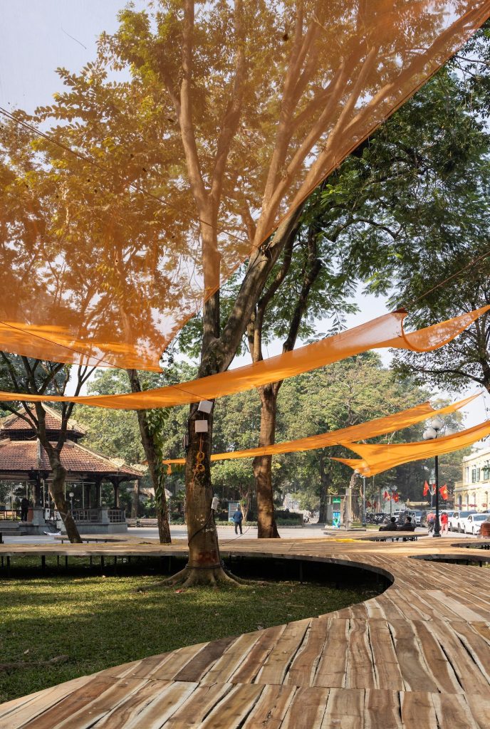 Deck curving around a tree under orange shade