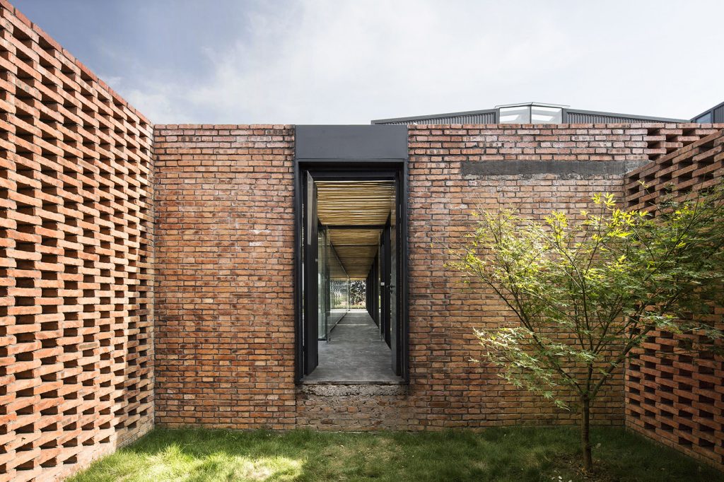 Perforated brick walls around the factory service courtyard