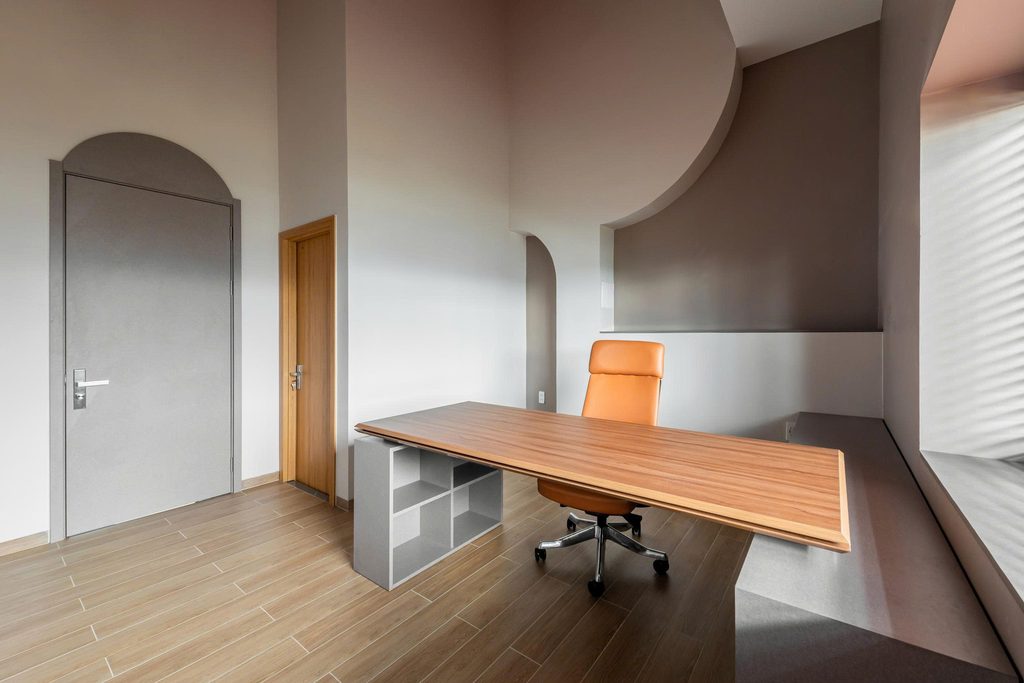 Study with a timber desk and curved wall details