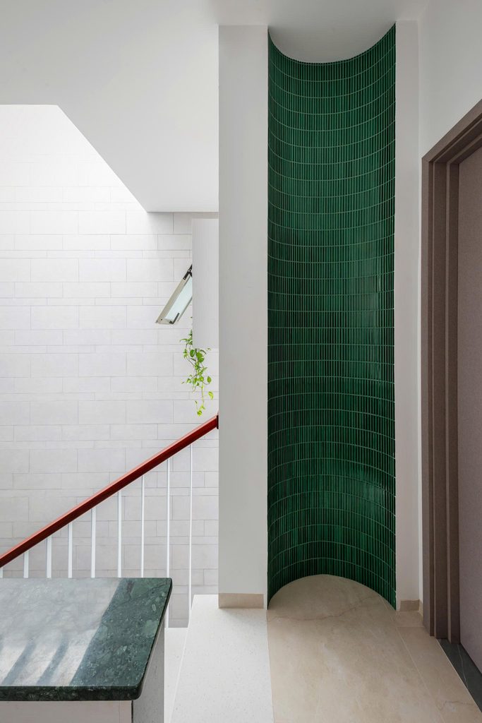 Curved green tiled wall beside the upper landing