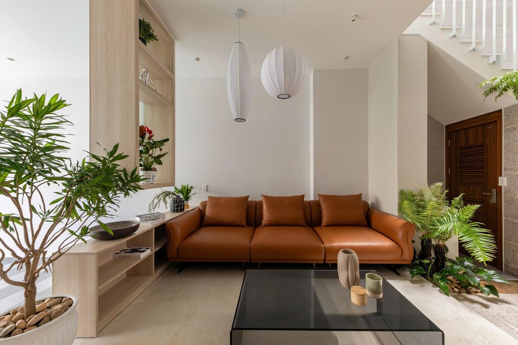 Living room seating beside indoor greenery
