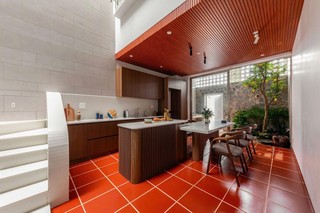 Raised kitchen and dining area with red floor tiles