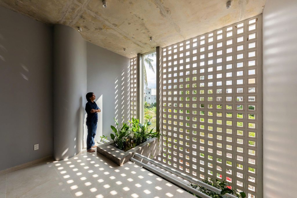 Quiet room with a perforated screen and exposed concrete ceiling