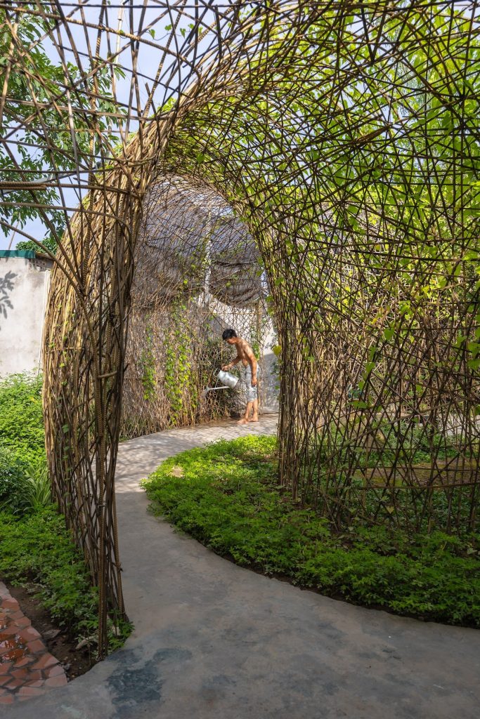 A woven arch over the curving path