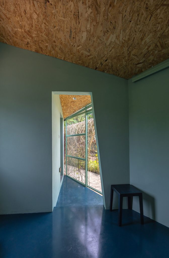 Room with blue-grey walls and a deep blue floor