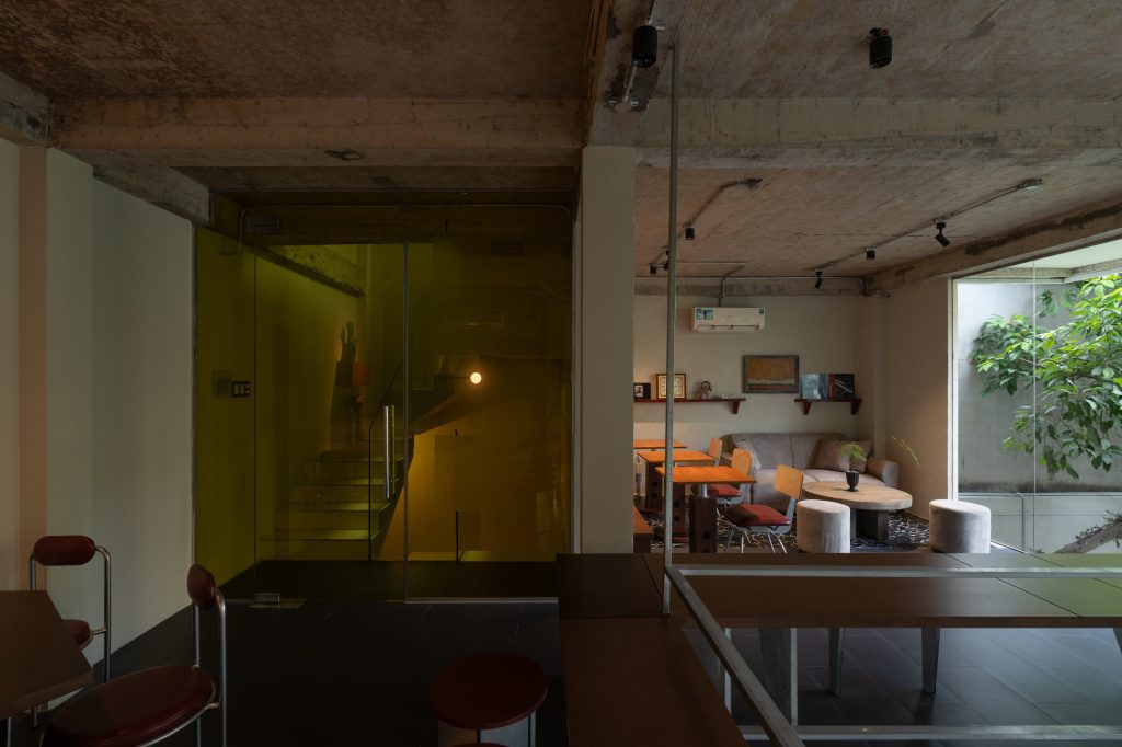 Day1 Cafe by oh.hi studio, upper-level seating in low light