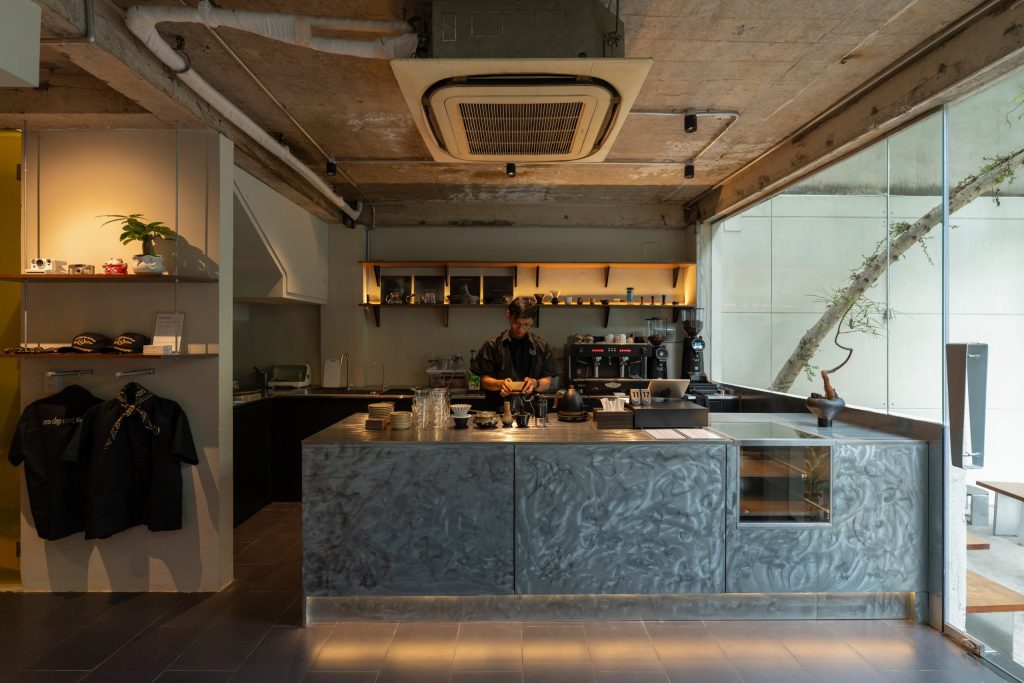 Day1 Cafe by oh.hi studio, bar counter under the exposed concrete ceiling