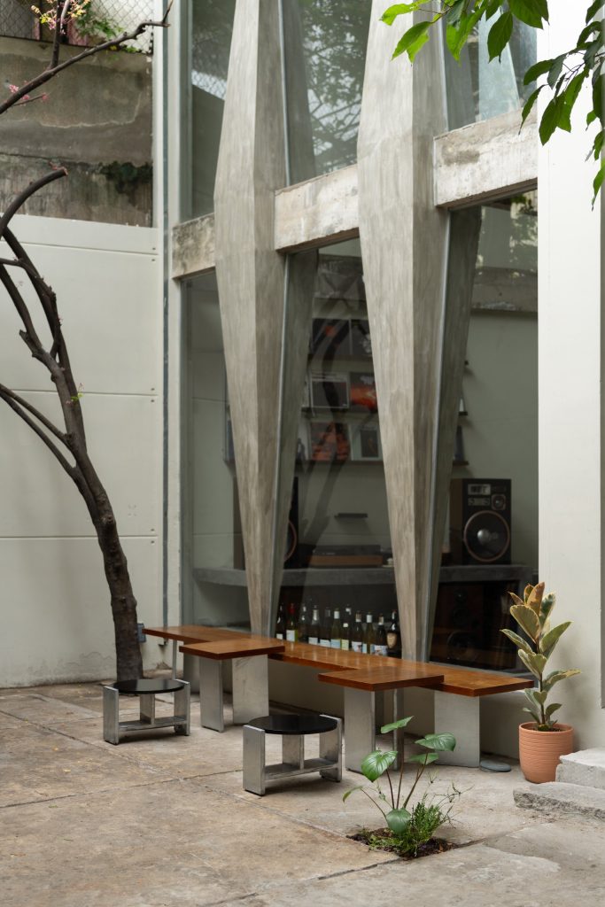 Day1 Cafe by oh.hi studio, courtyard with a tree and benches before the façade
