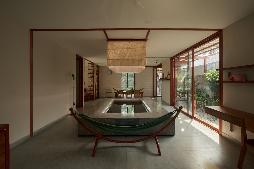 Garden House by aha.studio.arc, Go Quao, An Giang, shared living space with hammock