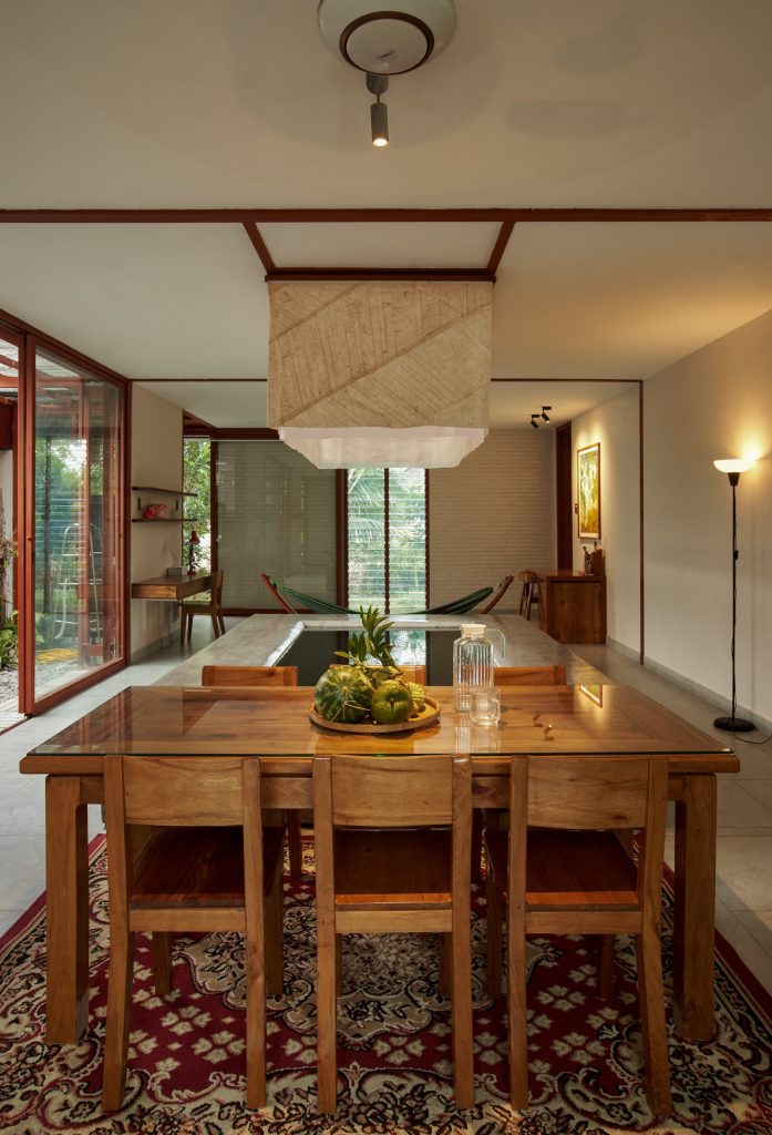 Garden House by aha.studio.arc, Go Quao, An Giang, dining table under the lantern